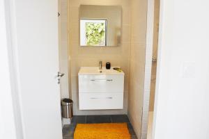 a bathroom with a white sink and a mirror at Logis Hôtel La Chaize in Noirmoutier-en-l'lle