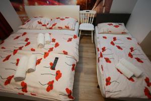 a bedroom with a bed with red leaves on it at Apartments Rooms FONTANE TRNJE in Zagreb