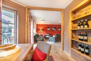 a dining room with a table and wine bottles at Große Wies in Oberstdorf