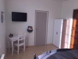 a bedroom with a bed and a table and a desk at le patio de l'oustal in Gimont