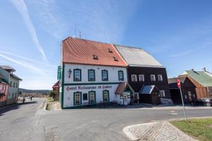 a building on the side of a street in a town at Hotel Svaty Hubert in Boží Dar