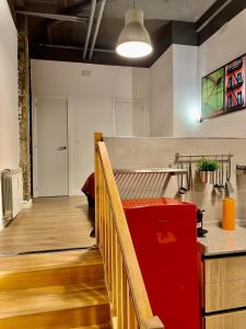 a room with a staircase with a red box at Loft Desing Retiro in Madrid