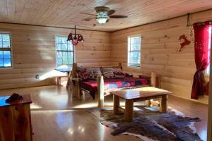 a living room with a couch and a table at Wild Reindeer 5min From Parkway HOTTUB FIREpit in Sevierville