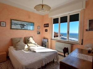 a bedroom with a bed and a view of the ocean at Villa Sole in Imperia