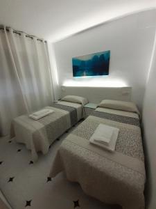 Posteľ alebo postele v izbe v ubytovaní Hostal Kokkola
