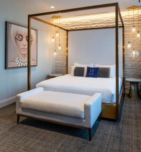 a bedroom with two beds and a large mirror at The Hotel & Athletic Club at Midtown in Chicago