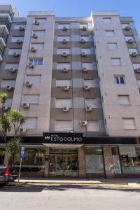 a large apartment building with a store front at Estocolmo Hotel by bund in Mar del Plata