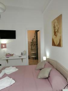 a bedroom with a large bed with a painting on the wall at Trastevere & Gianicolo Sweet Rest in Rome
