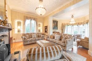 a living room with couches and a fireplace at Florence Nightingale Suites at Lea Hurst in Highpeak Junction