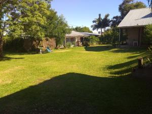 a yard with a large shadow of a house at Blue House in Concordia
