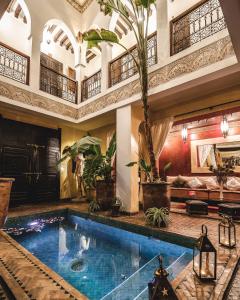 a large indoor swimming pool in a building at Riad Aguaviva in Marrakech