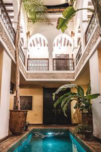 a swimming pool in a house with a ceiling at Riad Aguaviva in Marrakech