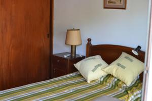 a bedroom with a bed with two pillows on it at SL 1908 in Olivos