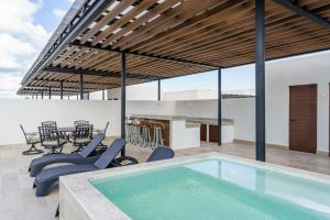 a house with a swimming pool and a patio at Oceana by ABNA in Playa del Carmen