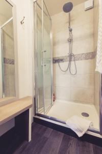 a bathroom with a shower with a glass door at La Maison de la Liberté Alexandra David-Néel in Poitiers