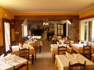 a restaurant with tables with white tablecloths at Hostal Barnes in Santa Cristina d'Aro