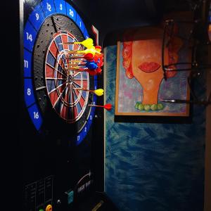 a dart board and a picture of a woman at Varad INN in Novi Sad