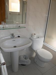 a bathroom with a white toilet and a sink at Hostal Barnes in Santa Cristina d'Aro