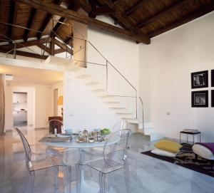 a dining room with a glass table and chairs at Right House - Characteristic Marina District in Cagliari