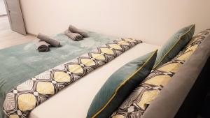 a bed with pillows on it in a room at Centrum Warszawy - City Center the best places, metro Centrum & Świętokrzyska, partial view of the Palace of Culture, self check-in, AC, optional breakfest in Warsaw