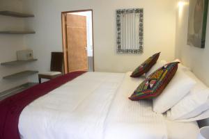 Rúm í herbergi á Cotinga Hotel Spa