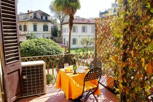 a table with a yellow table cloth on a balcony at Bartolomeo in Florence
