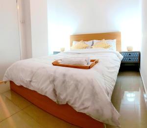 a bedroom with a large bed with a wooden headboard at Amazing Modern Room 4 Min From The Tram in Jerusalem