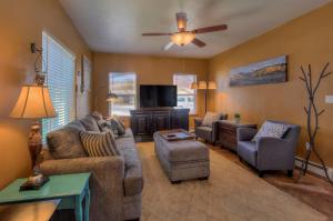a living room with couches and a flat screen tv at Cali Cochitta Vacation Rentals in Moab