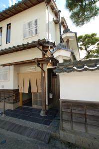 a building with a gate and a fence at 三上勘兵衛本店 Mikami Kanbe Honten in Miyazu
