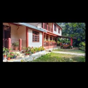 a house with potted plants in front of it at Tenam Garden homestay in Kalimpong