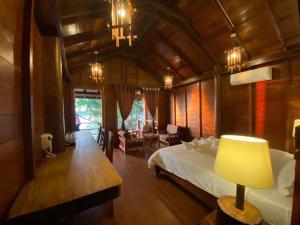 a bedroom with a bed and a table with a lamp at Stung Treng Resort in Stœ̆ng Trêng