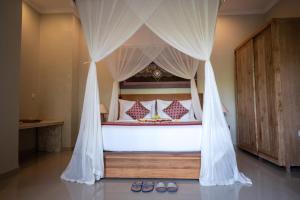 Postel nebo postele na pokoji v ubytování Nata Ubud