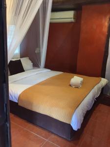 Postel nebo postele na pokoji v ubytování Ban Din Resort Chiang Rai