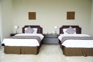 Postel nebo postele na pokoji v ubytování Arainn Bed & Breakfast Tretes Prigen by ecommerceloka