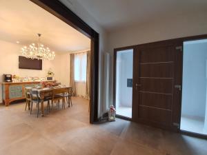 uma cozinha e sala de jantar com uma mesa e um lustre em Villa Elisa em Gambettola
