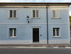 a blue building with a door and windows at Villa Elisa in Gambettola
