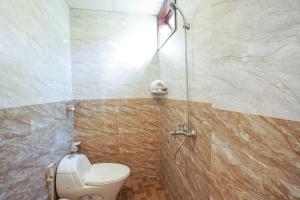a bathroom with a toilet and a shower at Windy River Homestay in Hoi An +66 photos