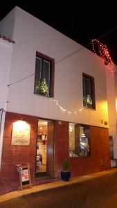 a building with christmas lights on the side of it at Born To Stay In Milfontes in Vila Nova de Milfontes