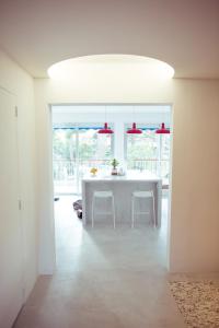 卡西斯的住宿－Le Canaillou par Dodo-a-Cassis，白色的厨房配有桌子和一些椅子