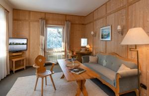 a living room with a couch and a table at Klostergasthof Maria Eck in Siegsdorf