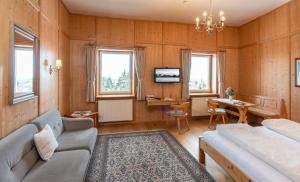 a living room with a couch and a table at Klostergasthof Maria Eck in Siegsdorf