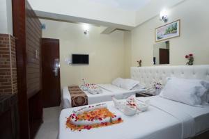 a room with two beds with a cake on it at Hotel Vista Bay in Cox's Bazar