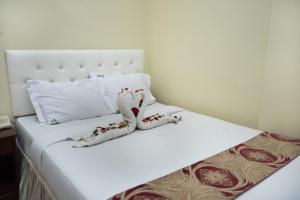 a white bed with christmas decorations on it at Hotel Vista Bay in Cox's Bazar