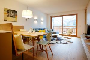 ein Esszimmer und ein Wohnzimmer mit einem Tisch und Stühlen in der Unterkunft Landhaus Bergpanorama TOP 7 in Damüls