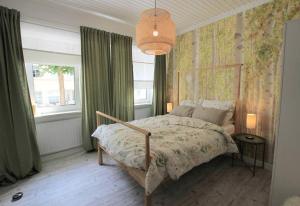 a bedroom with a bed and a chandelier at FerienNest Bad Ems, Appartment WaldNest in Bad Ems