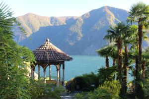 a gazebo with a view of a lake and mountains at Barony Le Pergole holiday apartments Lugano in Lugano