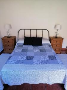 a bedroom with a bed with a blue quilt on it at Casa Juana in Valle Gran Rey