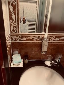 a bathroom with a white toilet and a mirror at Hotel Vittoria in Milan