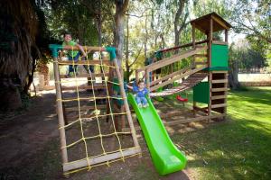 two children playing on a slide at a playground at Damnoni Paradise in Damnoni