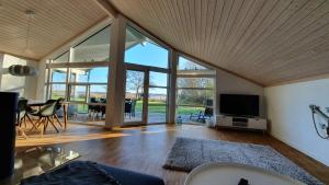 a living room with a large window and a tv at Haus Seeblick in Timmendorfer Strand